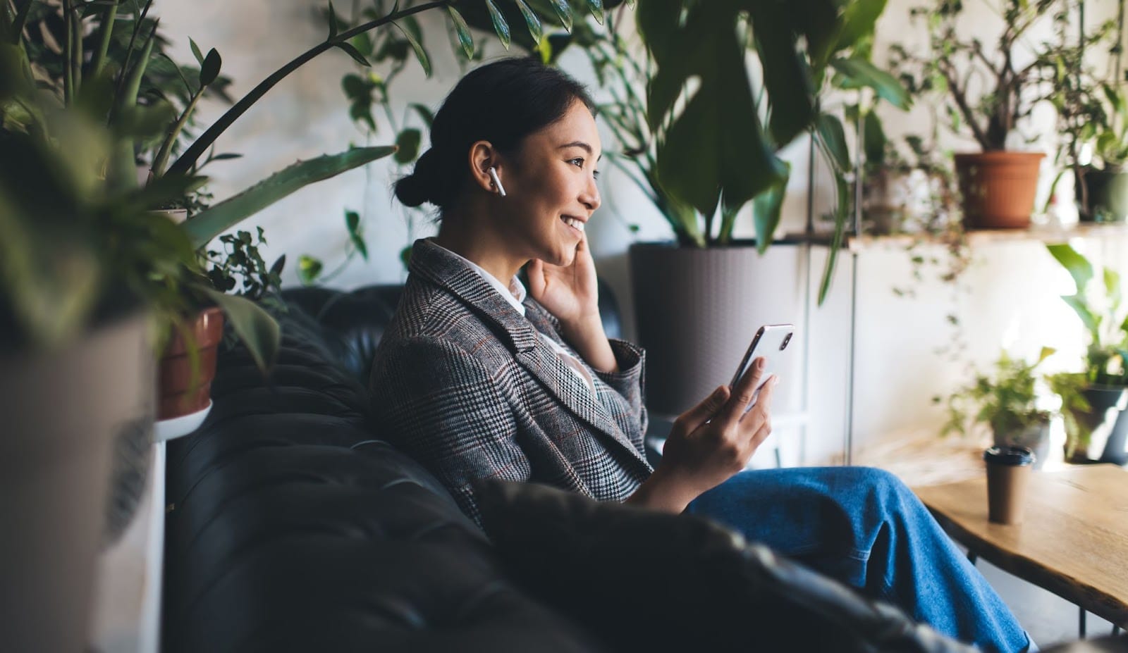 Woman using active noise-cancelling earbuds during travel